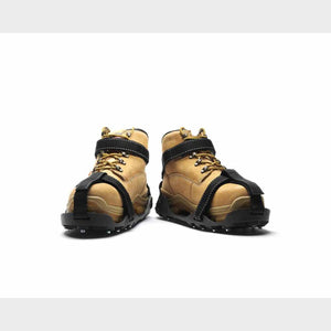 Tan work boots with black ice traction cleats attached