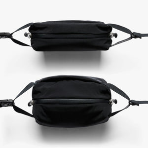 Top and bottom views of a black Bellroy sling bag with zipper closure