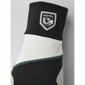 Hestra glove cuff with black and white panels and brand logo patch