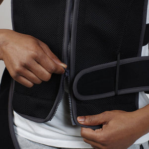 Person zipping up a black Oro Sports mesh vest