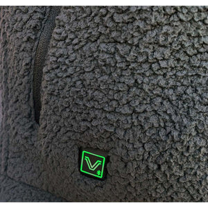 Close up of black sherpa fleece fabric with a square V logo patch