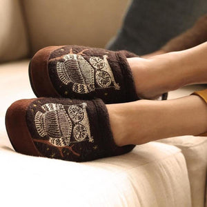 Acorn brown slippers with embroidered owl design worn on feet