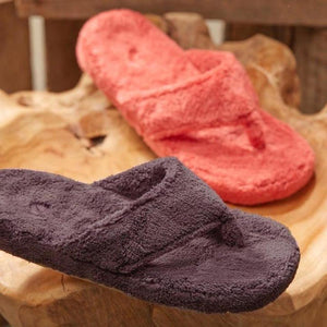 Acorn fuzzy thong slippers in coral and dark purple on a wooden surface