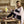 Woman wearing Acorn slippers sitting on a wooden bench eating breakfast