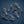Group of seven metal screws with hex heads on a dark blue background