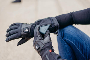 Person inserting a battery pack into an ActionHeat heated glove