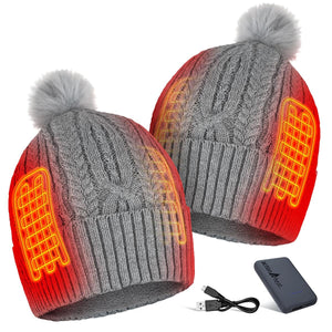 Two grey ActionHeat cable knit beanies with pom poms showing internal heating elements and a power bank