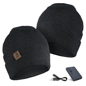 Two black ActionHeat knit beanies with a power bank and USB charging cable