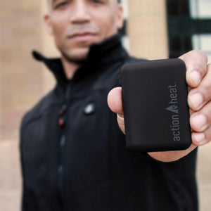 Man holding a black ActionHeat power bank