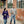 Man and woman walking on sidewalk holding coffee cups