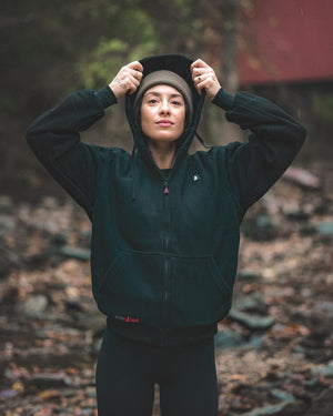 Person wearing a black ActionHeat zip up hoodie with a beanie outdoors