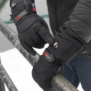Person wearing black ActionHeat heated gloves with illuminated power button on wrist