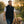 Man wearing a black ActionHeat fleece vest walking a golden retriever on a path