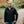 Man wearing a black ActionHeat softshell heated jacket outdoors