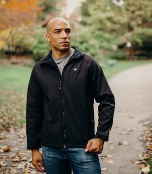 Man wearing a black ActionHeat softshell heated jacket outdoors