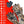ActionHeat camouflage heated gloves with two power banks and feature list on red background