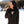 Woman wearing black ActionHeat long sleeve shirt pointing to the power button in a snowy outdoor setting