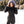 Woman wearing a black quilted winter jacket with a faux fur hood in a snowy outdoor setting