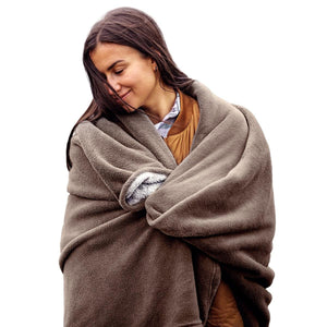 Woman wrapped in a brown ActionHeat heated blanket