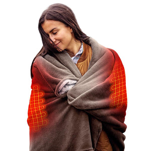 Person wrapped in a brown ActionHeat heated blanket with visible red heating elements