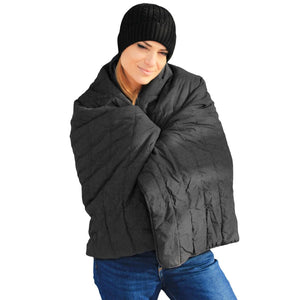 Woman wearing a black beanie and wrapped in a black ActionHeat quilted blanket