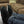 ActionHeat black heated slippers worn on feet resting on a table