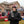 Man wearing Arizona Cardinals branded winter gear holding a steaming mug at a tailgate party
