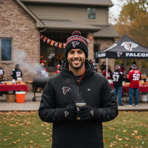 Man wearing ActionHeat Atlanta Falcons branded jacket hat and gloves holding a steaming mug at a tailgate