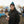 Man wearing ActionHeat jacket and Carolina Panthers beanie holding a steaming cup at a tailgate
