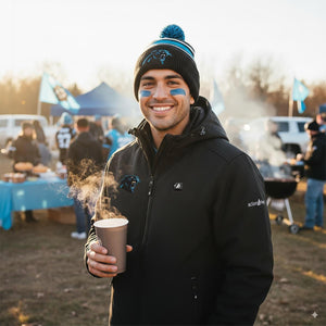 Man wearing ActionHeat jacket and Carolina Panthers beanie holding a steaming cup at a tailgate