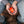 ActionHeat rechargeable hand warmer with glowing red bear logo held in hands