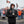 Man wearing ActionHeat black heated jacket and gloves holding a steaming cup at a Cleveland Browns tailgate