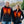 Man and woman wearing ActionHeat black heated vests with glowing chest heating elements
