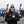 Man wearing ActionHeat jacket and Denver Broncos beanie holding a steaming cup at a tailgate
