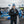Man wearing ActionHeat jacket and Detroit Lions beanie holding a steaming mug at a tailgate