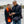 Woman wearing ActionHeat heated scarf and man wearing ActionHeat heated vest looking at a smartphone
