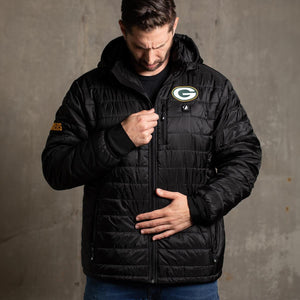 Man wearing a black Green Bay Packers hooded puffer jacket with team logo on chest