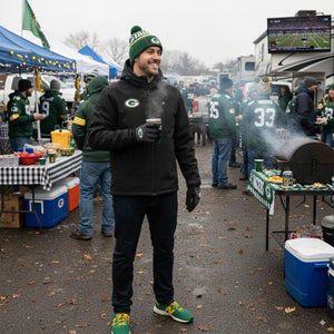 Man wearing ActionHeat jacket and Green Bay Packers gear at a tailgate party