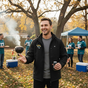Man wearing a black Jacksonville Jaguars softshell jacket at an outdoor tailgate party