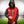 Man wearing a red and black ActionHeat Kansas City Chiefs hooded varsity jacket on a football field