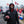 Man wearing Kansas City Chiefs apparel holding a football at a tailgate party
