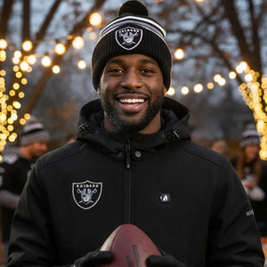 Man wearing ActionHeat Raiders branded jacket and beanie holding a football