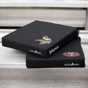 Two black ActionHeat heated seat cushions with Minnesota Vikings and San Francisco 49ers logos on metal bleachers