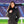 Woman wearing a black ActionHeat quilted jacket with a faux fur hood at a stadium