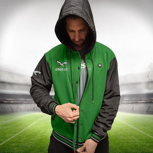 Man wearing a green and black Philadelphia Eagles hooded varsity jacket with snap buttons