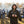 Man wearing ActionHeat Tennessee Titans hooded jacket holding a steaming mug at a tailgate