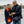 Woman wearing ActionHeat heated scarf and gloves while man wears ActionHeat heated vest looking at a smartphone