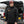 Man wearing a black Washington Commanders heated jacket and a matching knit beanie standing by an open car trunk