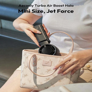 Person placing a black Aecooly Turbo Air Boost Halo portable fan into a small handbag