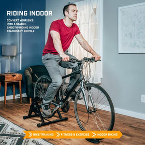 Man using an Alpcour indoor bike trainer stand in a living room